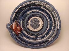 a blue and white bowl with an orange object in the center