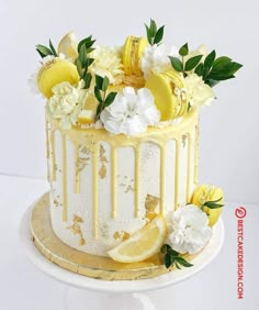 a white cake with lemons and flowers on top