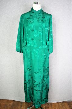 "This is a beautiful garment.  It is in a true, saturated green silk.  It is lined , has covered buttons and bound buttonholes.  There are no tares or stains and looks to have rarely if ever been worn.   The hem has been fixed.  Marked size 8 38\" bust 36\" waist 40\" hip 16\" shoulder to shoulder 20\" sleeve 52\" nape to hem  Purveyor's Note: We have searched far and wide, wrestled bears, braved the cold, traversed mountain ranges, fought pirates, swam with sharks and eaten at many a questionable road side taco stand to provide our customers with one of a kind vintage pieces.  Know that whichever piece you choose to make your own has its own story and has traveled through time to get to you.  Though we strive to provide the absolute best, \"pristine\" vintage pieces are rare birds, if not Fitted Green Silk Long Sleeve Dress, Green Silk Dress For Spring Formal Occasion, Green Silk Dress For Spring Formal, Green Silk Dress For Formal Occasions, Green Silk Evening Dress, Formal Green Silk Dress, Elegant Green Silk Dress For Formal Occasions, Green Long Sleeve Silk Spring Dress, Green Silk Dress For Spring