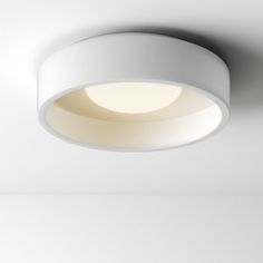 a white circular light fixture mounted on the ceiling