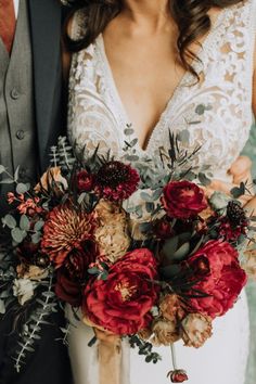 the bride and groom are holding their bouquets