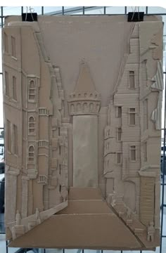 a cardboard cut out of a building with a tower