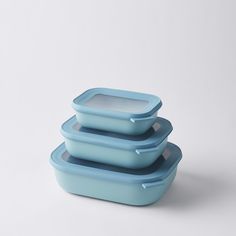 three blue rectangular containers stacked on top of each other with one container in the middle