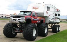 a monster truck with a camper on it's back