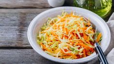 a white bowl filled with coleslaw and carrots