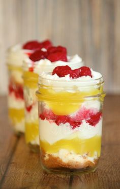 three jars filled with food sitting on top of a wooden table