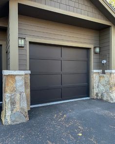 two garage doors are shown in front of a house with stone pillars and columns on the side