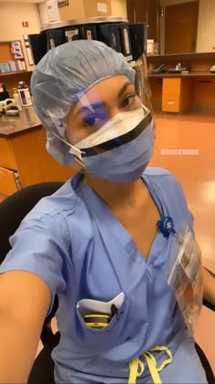 a woman in scrubs is sitting down