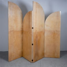 a room divider made out of wood with two doors on one side and an open door on the other