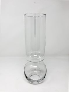 a clear glass vase sitting on top of a white table