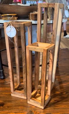 two wooden boxes sitting on top of a hard wood floor