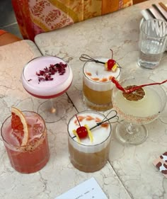 four different types of cocktails on a table