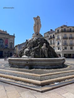 a fountain in the middle of a city square