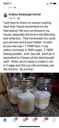 two jars filled with white sand sitting on top of a counter next to each other