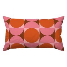 an orange and pink pillow with circles on it