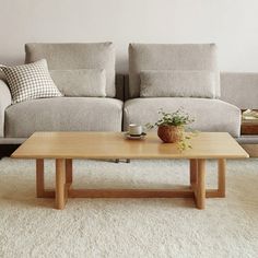 a living room with two couches and a coffee table in front of the couch