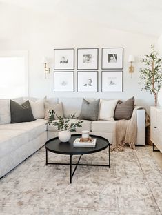 a living room filled with lots of furniture and pictures on the wall above it's coffee table