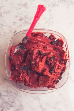 a bowl filled with ice cream and chocolate chips on top of a marble countertop