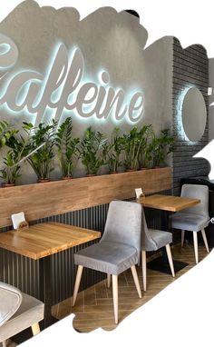 the interior of a restaurant with wooden tables and grey chairs, plants on the wall