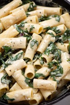 pasta with spinach and cheese in a skillet