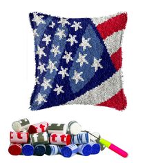 an american flag pillow and some crayons on a white background with the colors red, white, and blue