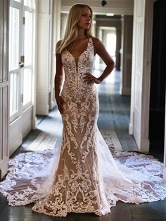 a woman in a wedding dress standing on the floor