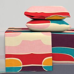 three pillows are stacked on top of each other