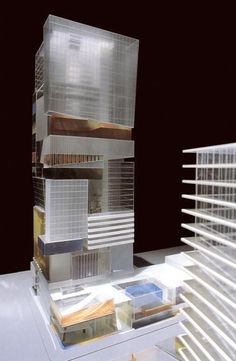 a model of a tall building with lots of windows on it's front and side