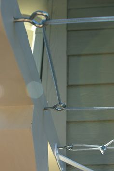 a close up of a metal fence on the side of a house