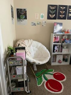 there is a baby crib in the corner next to a book shelf and bookshelf