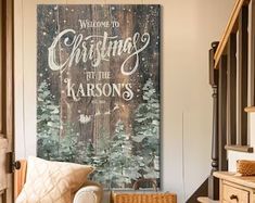 a christmas sign hanging on the wall above a chair in a room with wooden stairs