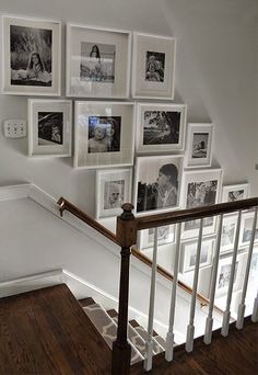 there is a staircase with pictures on the wall