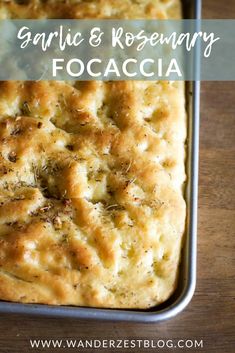 garlic and rosemary focaccia in a baking pan with text overlay that reads garlic and rosemary focaccia