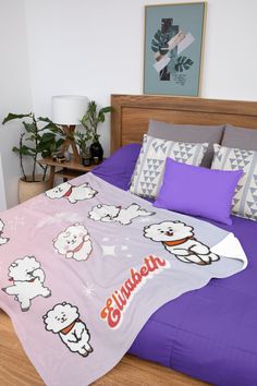 there is a bed with purple sheets and white sheeps on the comforter in this bedroom