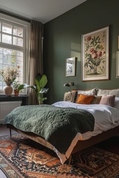 a bed sitting in a bedroom next to a window covered in green blankets and pillows