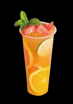 a tall glass filled with watermelon, lime and lemonade on a black background