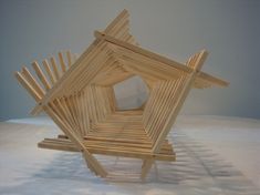 a wooden structure sitting on top of a white surface