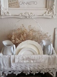 there is a white table setting with lace on it