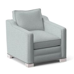 a gray chair sitting on top of a white floor