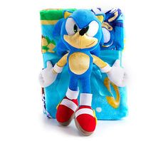 sonic the hedge plush toy sitting next to a blue and yellow blanket on a white background