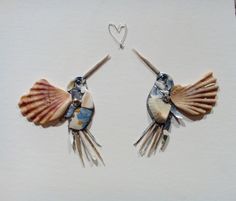 two small seashells are attached to silver earwires with heart shaped hooks