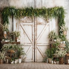 an old door is decorated with greenery and potted plants