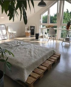 a large bed sitting in the middle of a bedroom