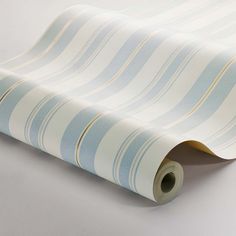 a roll of white and beige striped wallpaper