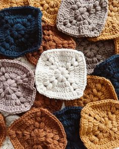 several crocheted squares are arranged on top of each other in different colors and sizes