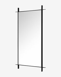 a mirror that is on the wall with black bars around it and one side has a white background