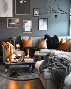 a living room filled with lots of furniture and pictures on the wall above it's coffee table