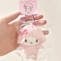 a hello kitty keychain is being held by someone