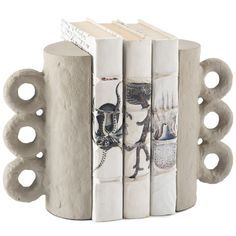 three books are stacked on top of each other in the shape of a bookend