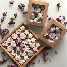 two boxes filled with buttons and flowers on top of a table